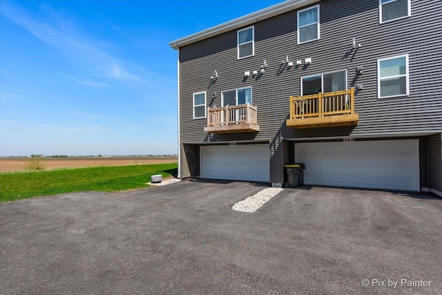 rear view of house with a garage and driveway