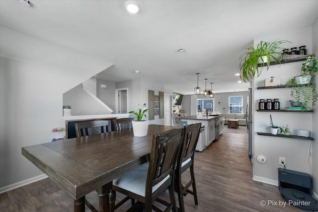 dining area featuring dark wood-type flooring, baseboards, and recessed lighting