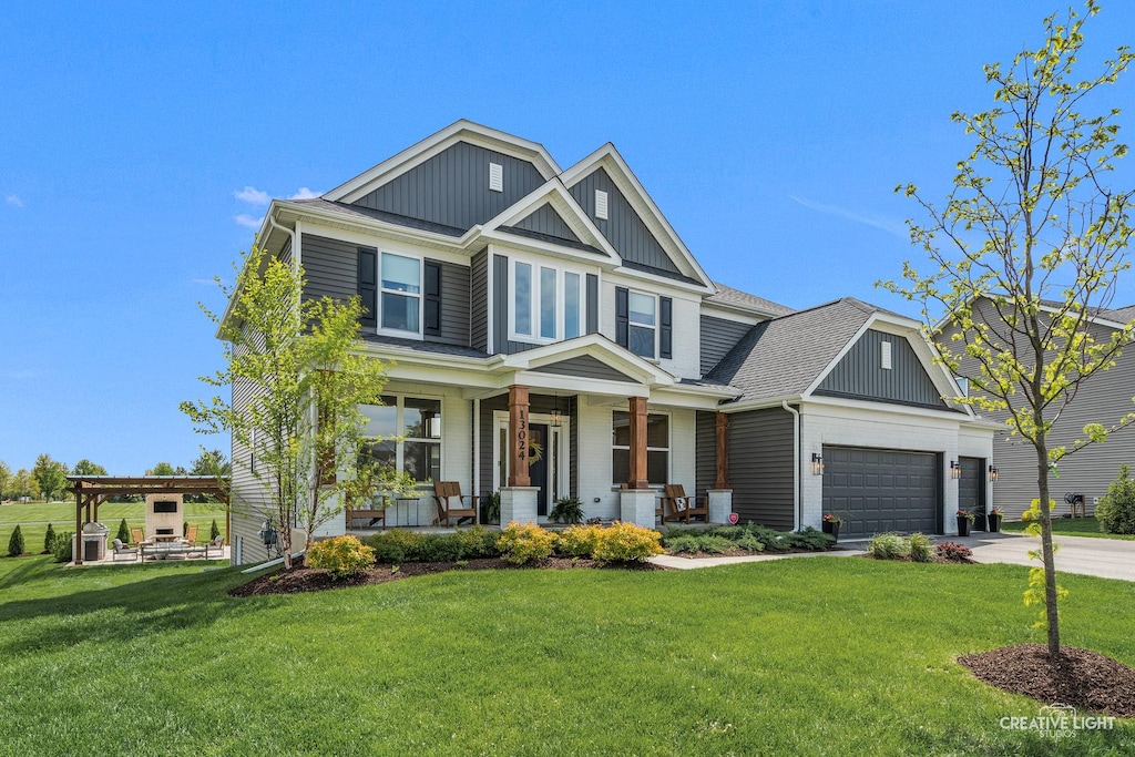 13024 S Timber Wood Cir, Plainfield, IL 60585 - craftsman inspired home with a porch, board and batten siding, concrete driveway, a front lawn, and roof with shingles