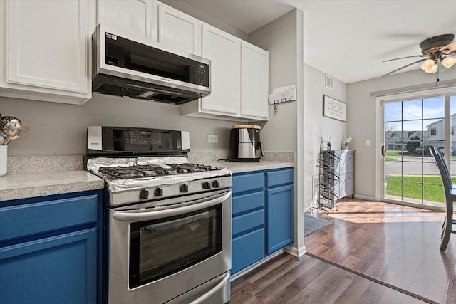 12777 W Wakefield Dr, Beach Park, IL 60083 - kitchen featuring stainless steel appliances, blue cabinetry, a ceiling fan, dark wood-style floors, and light countertops