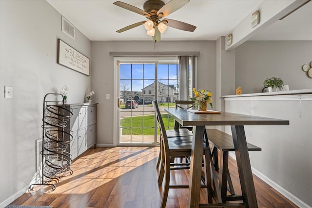 12777 W Wakefield Dr, Beach Park, IL 60083 - dining room with a ceiling fan, wood finished floors, and baseboards
