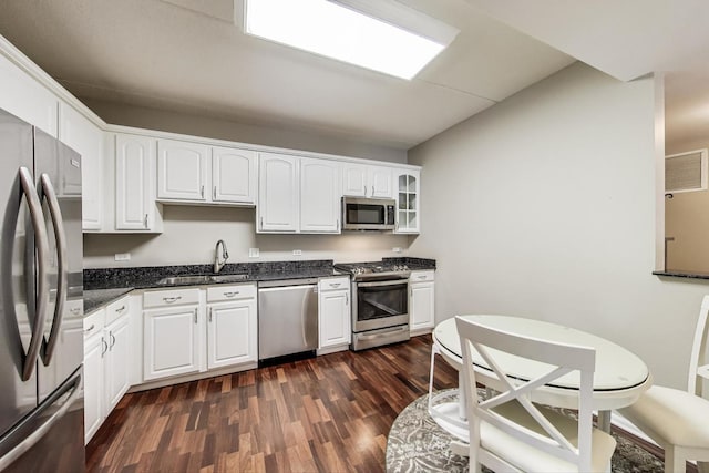 440 W Mahogany Ct Unit 209, Palatine, IL 60067 - kitchen with appliances with stainless steel finishes, a sink, dark wood-type flooring, white cabinetry, and glass insert cabinets