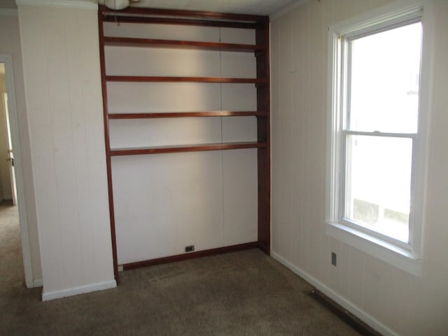unfurnished room featuring carpet floors and baseboards