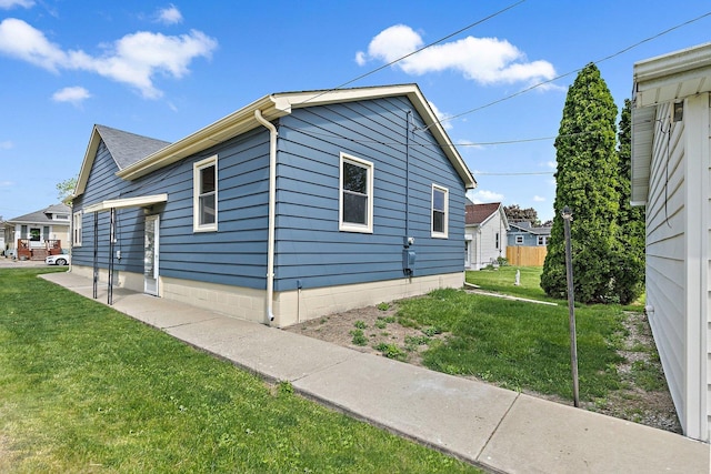 view of side of home featuring a yard