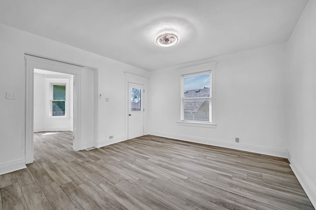 empty room featuring wood finished floors and baseboards