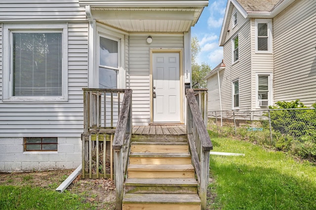 view of exterior entry with fence