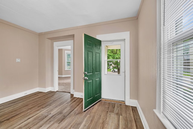 entrance foyer with light wood finished floors and baseboards
