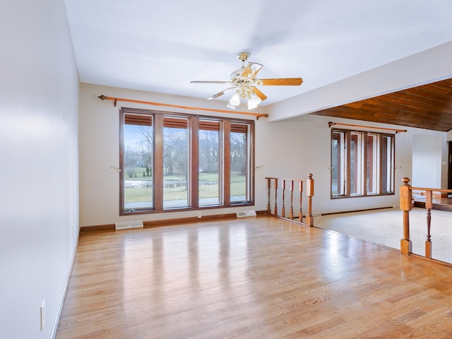 spare room featuring ceiling fan, wood finished floors, and baseboards