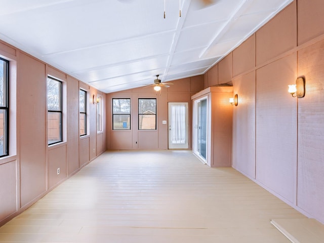 unfurnished sunroom featuring lofted ceiling