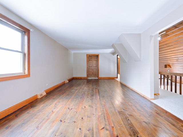 bonus room featuring wood-type flooring and baseboards