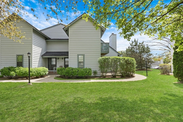 view of front of home featuring a front yard and a chimney