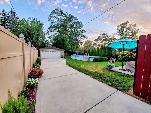 2153 W 107th Pl, Chicago, IL 60643 - yard at dusk featuring an outdoor structure, a swimming pool, and a detached garage