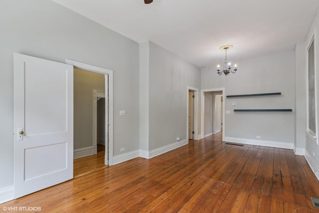 2232 W Homer St, Chicago, IL 60647 - unfurnished room featuring a chandelier, hardwood / wood-style flooring, and baseboards