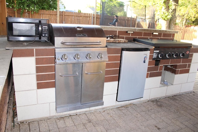 228 Janes Ave, Bolingbrook, IL 60440 - view of patio featuring a grill, an outdoor kitchen, and fence