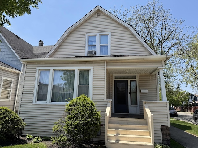 dutch colonial with a gambrel roof and a shingled roof