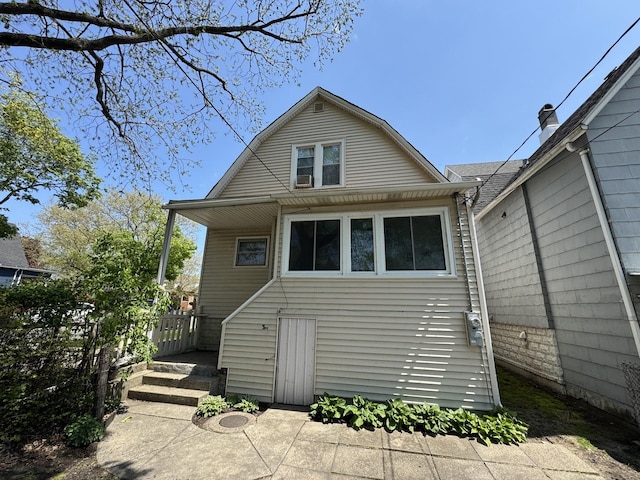 back of house featuring a gambrel roof
