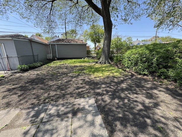 view of yard featuring fence and an outdoor structure