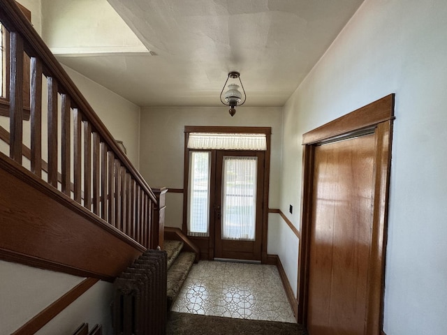 tiled entrance foyer with stairway and baseboards