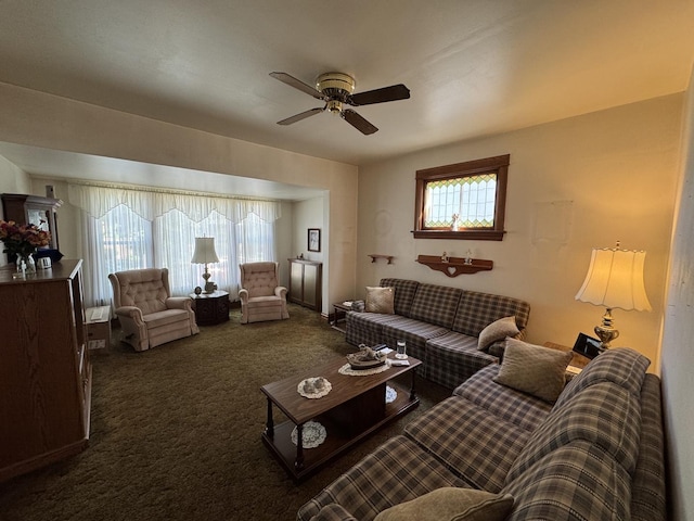 carpeted living area featuring a ceiling fan