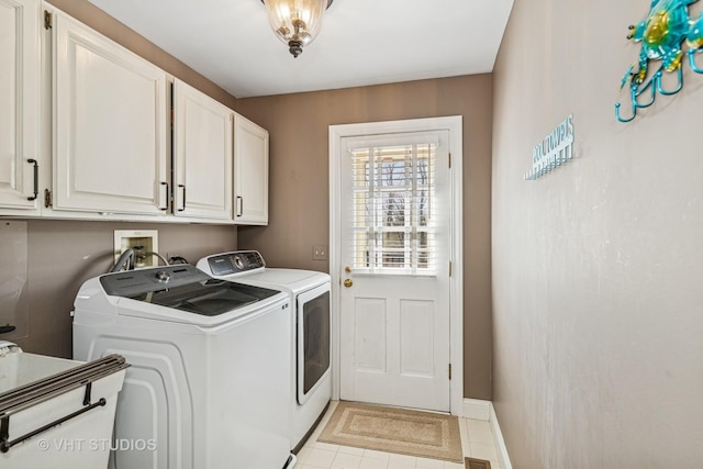 3937 Lakeview Ct, Long Grove, IL 60047 - washroom featuring separate washer and dryer, cabinet space, light tile patterned floors, and baseboards