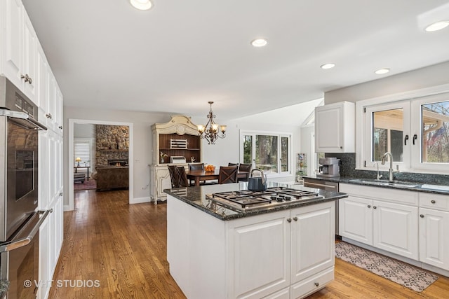 3937 Lakeview Ct, Long Grove, IL 60047 - kitchen with a sink, stainless steel appliances, a chandelier, a center island, and wood finished floors