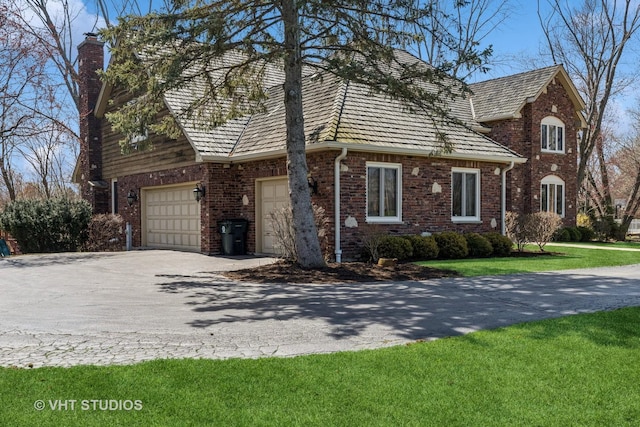 3937 Lakeview Ct, Long Grove, IL 60047 - view of property exterior featuring a chimney, driveway, brick siding, and a yard