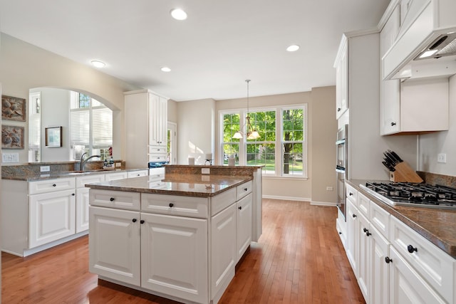 2904 Portage St, Naperville, IL 60564 - kitchen featuring a kitchen island, custom range hood, a sink, dark stone counters, and healthy amount of natural light