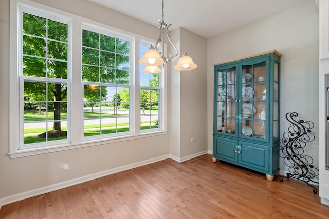 2904 Portage St, Naperville, IL 60564 - unfurnished dining area featuring a chandelier, baseboards, and light wood finished floors