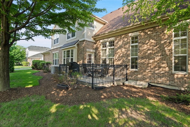 2904 Portage St, Naperville, IL 60564 - rear view of house featuring brick siding, a yard, central AC, and a wooden deck