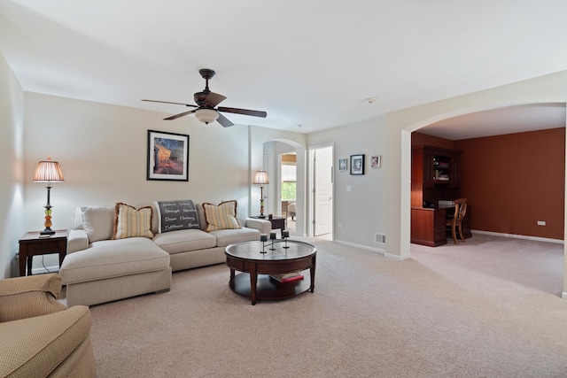 2904 Portage St, Naperville, IL 60564 - living room featuring arched walkways, ceiling fan, light carpet, and baseboards