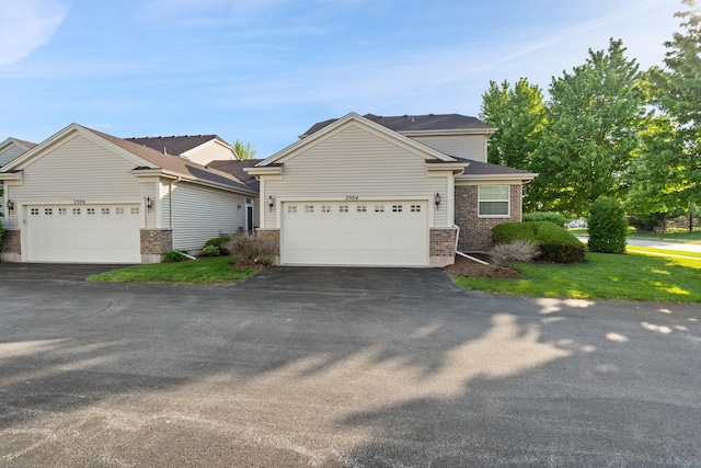 2904 Portage St, Naperville, IL 60564 - view of front of property featuring asphalt driveway, brick siding, a garage, and a front lawn