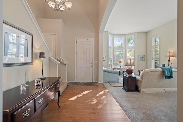 2904 Portage St, Naperville, IL 60564 - foyer entrance featuring wood finished floors, a chandelier, arched walkways, stairway, and baseboards