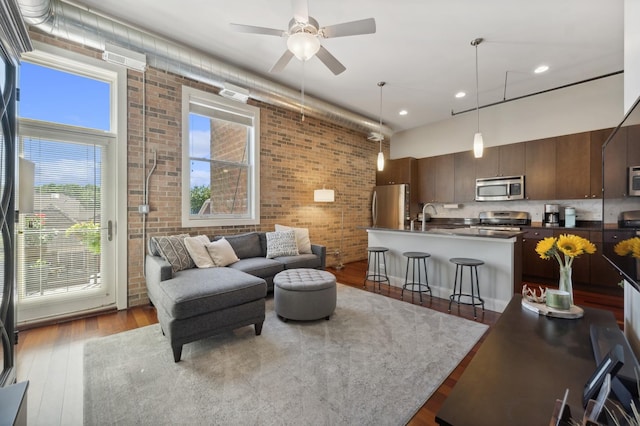 3133 N Lakewood Ave Unit 3I, Chicago, IL 60657 - living area with brick wall, wood finished floors, ceiling fan, and recessed lighting