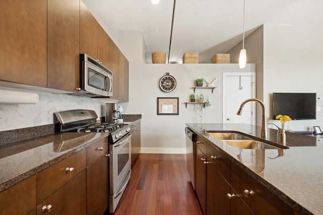 3133 N Lakewood Ave Unit 3I, Chicago, IL 60657 - kitchen featuring appliances with stainless steel finishes, a sink, baseboards, dark wood-style floors, and dark stone countertops
