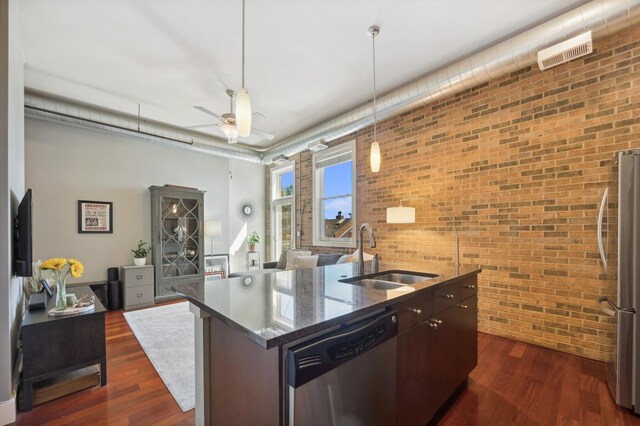 3133 N Lakewood Ave Unit 3I, Chicago, IL 60657 - kitchen with a sink, appliances with stainless steel finishes, brick wall, a kitchen island with sink, and a ceiling fan