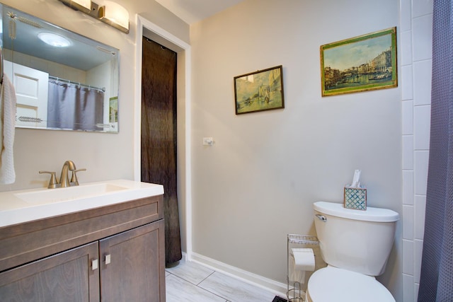 2006 Bristol Ct, Naperville, IL 60565 - bathroom with toilet, vanity, and baseboards