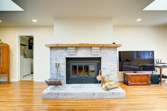 2006 Bristol Ct, Naperville, IL 60565 - detailed view of a fireplace, wood finished floors, recessed lighting, baseboards, and washer / dryer