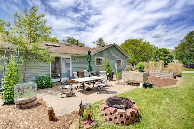 2006 Bristol Ct, Naperville, IL 60565 - back of property with an outdoor fire pit, a garden, a patio area, a lawn, and roof mounted solar panels