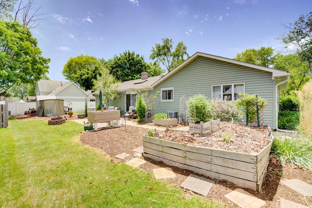 2006 Bristol Ct, Naperville, IL 60565 - back of property with a vegetable garden and a fire pit