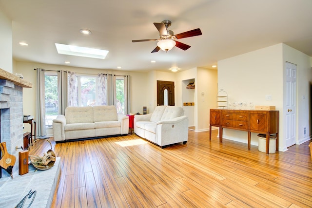 2006 Bristol Ct, Naperville, IL 60565 - living room with a ceiling fan, light wood finished floors, a brick fireplace, a skylight, and recessed lighting