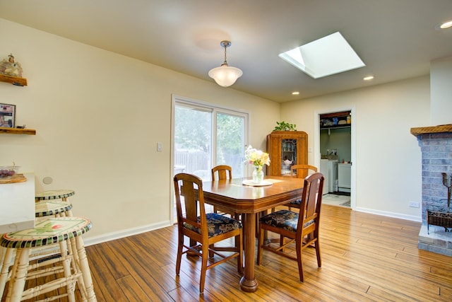 2006 Bristol Ct, Naperville, IL 60565 - dining room with a skylight, light wood finished floors, baseboards, washer / clothes dryer, and recessed lighting