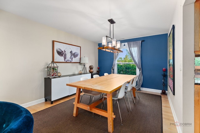 5538 Prairiemoor Ln, Long Grove, IL 60047 - dining room featuring a chandelier, light wood-style floors, and baseboards
