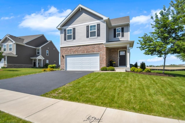 7605 Violet Ln, Joliet, IL 60431 - view of front facade with brick siding, asphalt driveway, a garage, and a front lawn