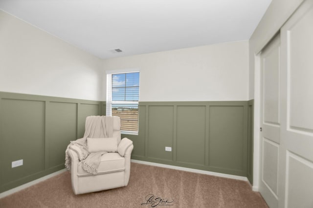 7605 Violet Ln, Joliet, IL 60431 - sitting room featuring a decorative wall, wainscoting, and carpet