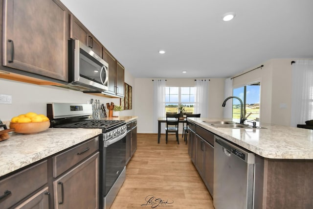 7605 Violet Ln, Joliet, IL 60431 - kitchen featuring appliances with stainless steel finishes, a sink, light wood-type flooring, light countertops, and dark brown cabinetry