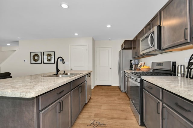 7605 Violet Ln, Joliet, IL 60431 - kitchen featuring appliances with stainless steel finishes, a sink, light countertops, light wood-style flooring, and dark brown cabinetry