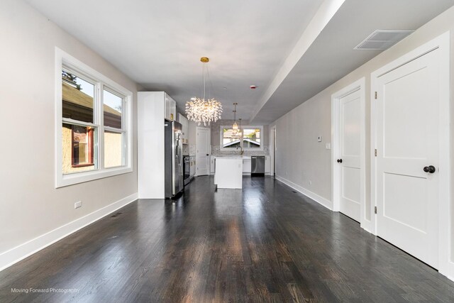 1179 S Taylor Ave, Oak Park, IL 60304 - unfurnished dining area featuring a chandelier, baseboards, and dark wood-style floors