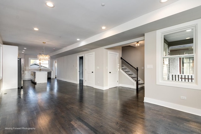 1179 S Taylor Ave, Oak Park, IL 60304 - unfurnished living room featuring a chandelier, stairs, recessed lighting, dark wood-type flooring, and baseboards