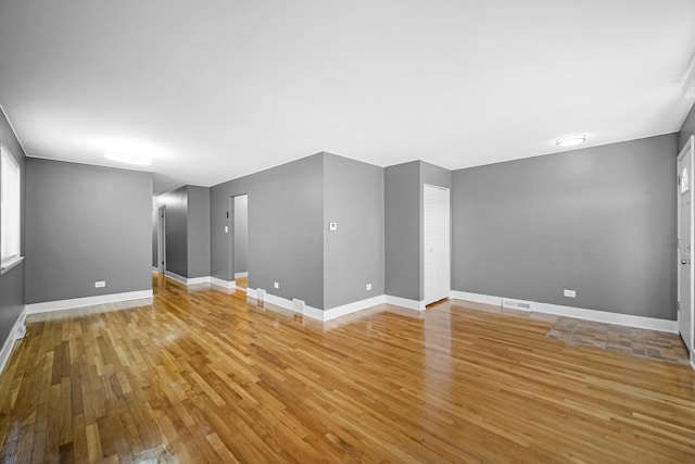 8851 S State St, Chicago, IL 60619 - unfurnished living room featuring light wood-style floors and baseboards