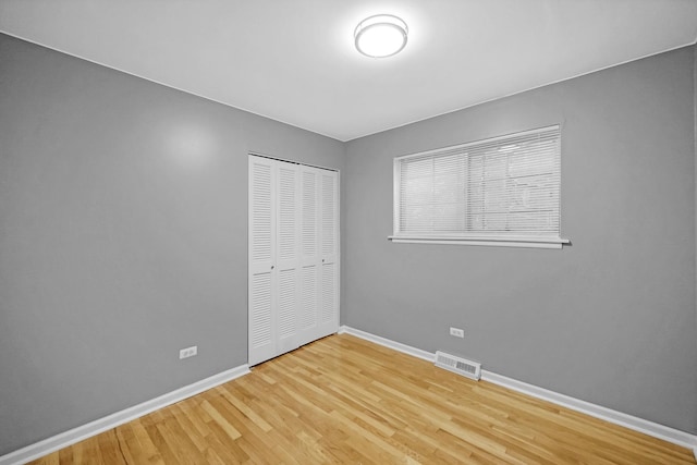 8851 S State St, Chicago, IL 60619 - unfurnished bedroom featuring baseboards, a closet, and wood finished floors